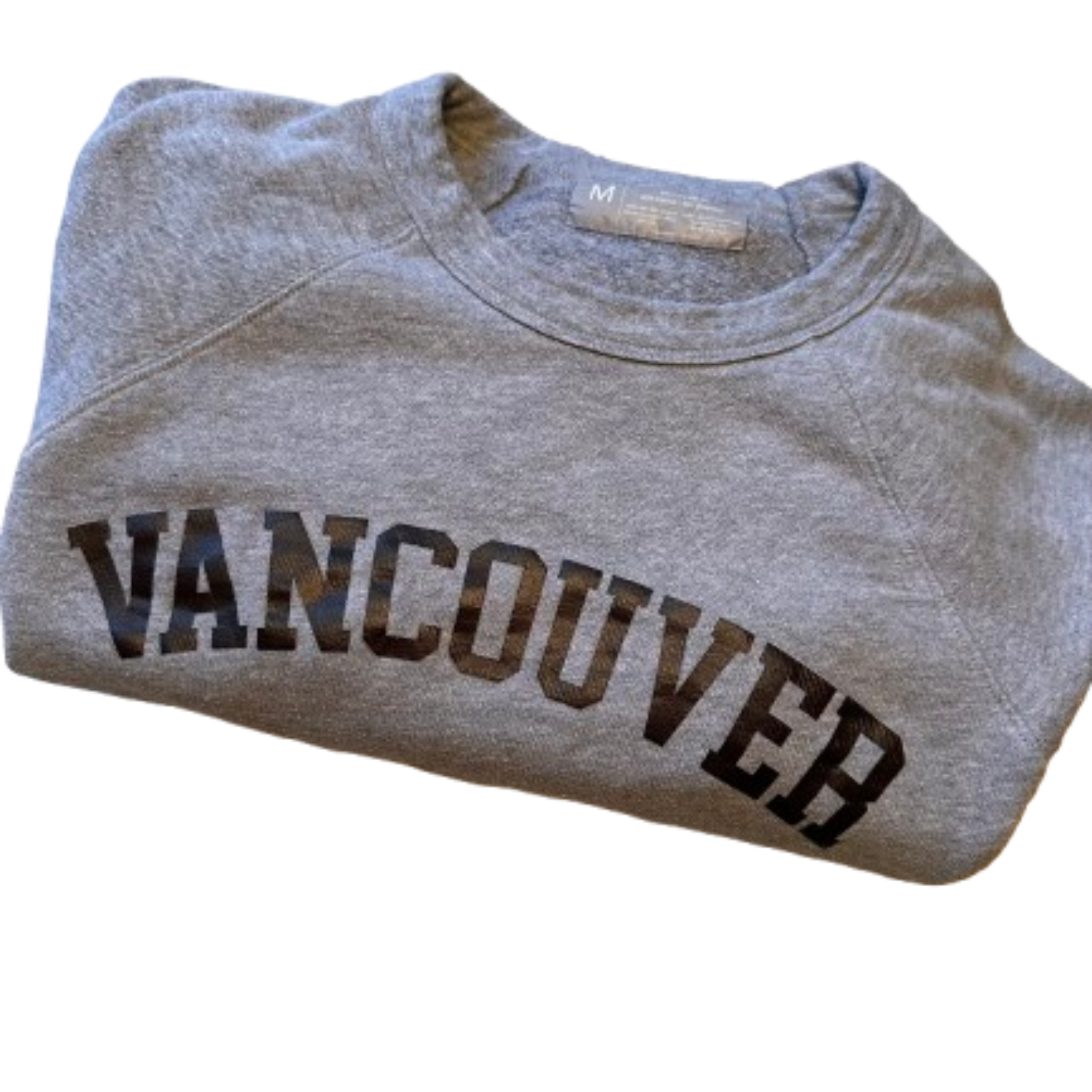 Folded gray sweatshirt with 'Vancouver' printed on it against a white background